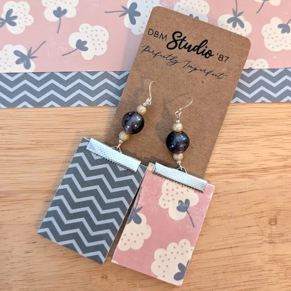 Medium rectangle dangle scrapbook paper earrings with silver accents and silver-purple pearlish beads. Salmon pink floral front; gray chevron back. Front and back shown.